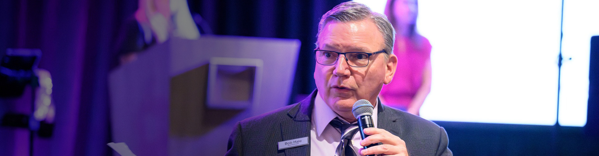 bob hale announcing the rules of the live auction at an event